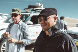 Scott Brady smiling, wearing a cap and sunglasses
